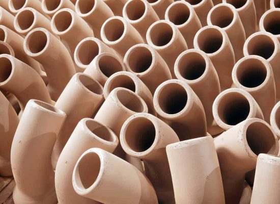 Close-up view of multiple tan ceramic plumbing pipes arranged in a clustered pattern, showcasing Pipeworks Plumbing and Construction’s durable pipe materials used in professional plumbing and construction projects. Close-up view of multiple tan ceramic plumbing pipes arranged in a clustered pattern, showcasing Pipeworks Plumbing and Construction’s durable pipe materials used in professional plumbing and construction projects.